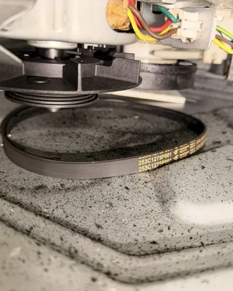 Washer drive belt that has slipped off the pulley under the washer